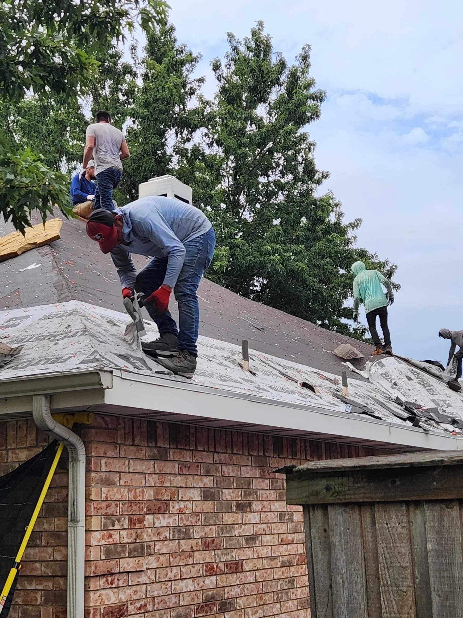 Roofers working on a residential roof