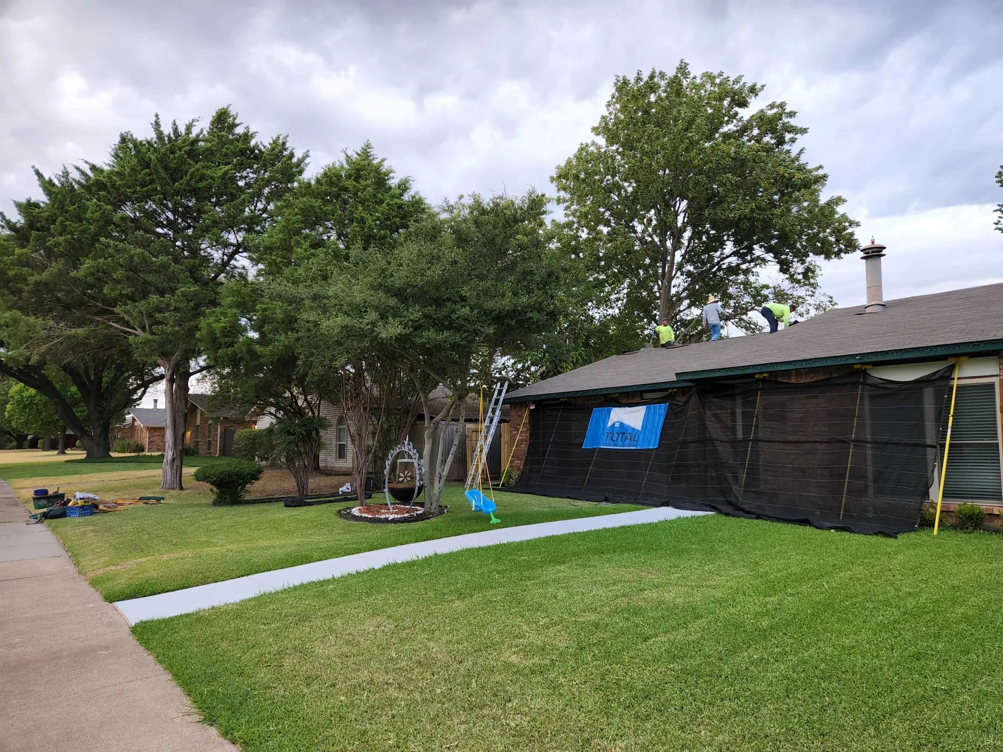 Roofing crew working on a residential roof