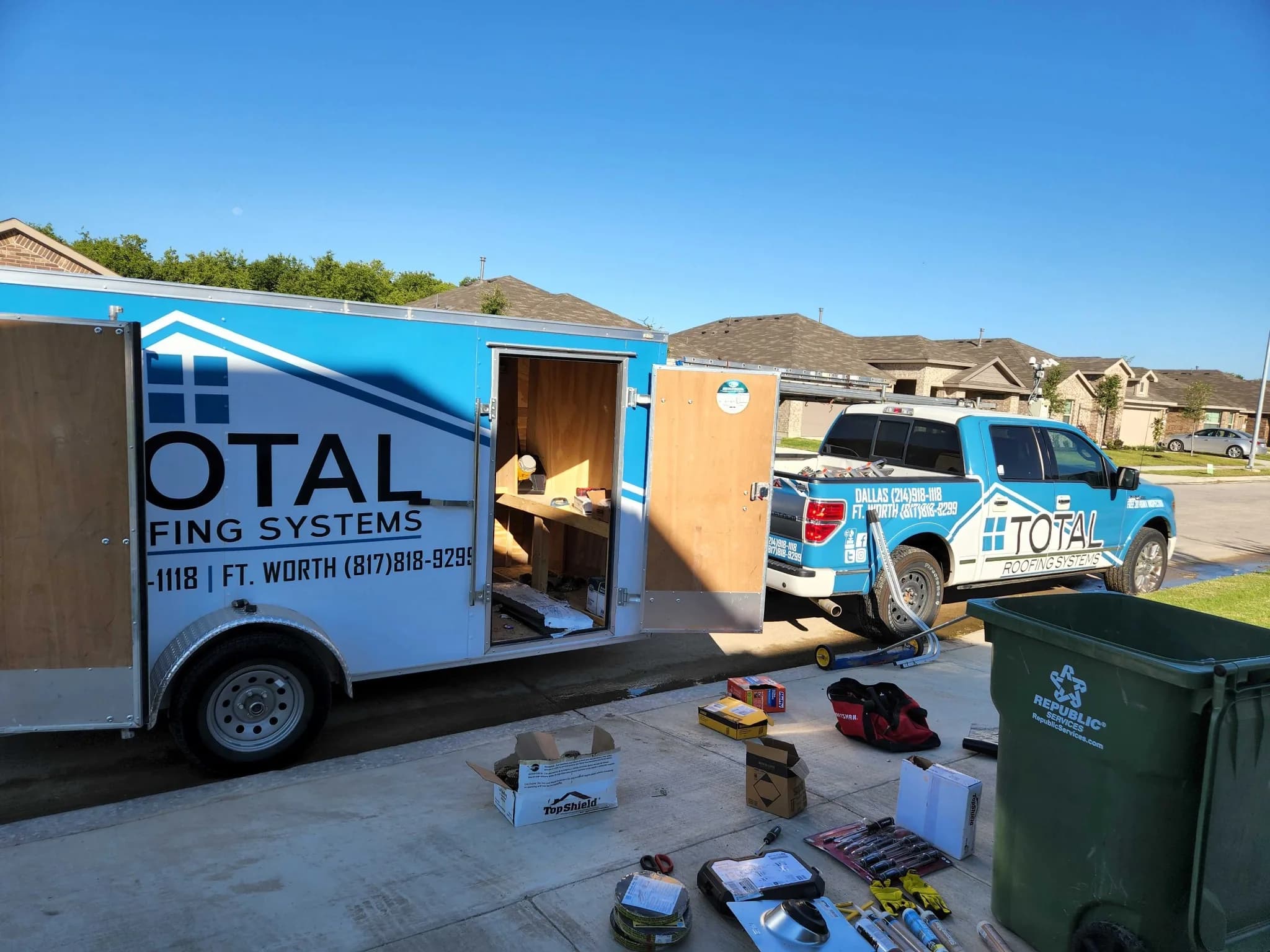 Total Roofing Systems truck and equipment at a residential roofing job